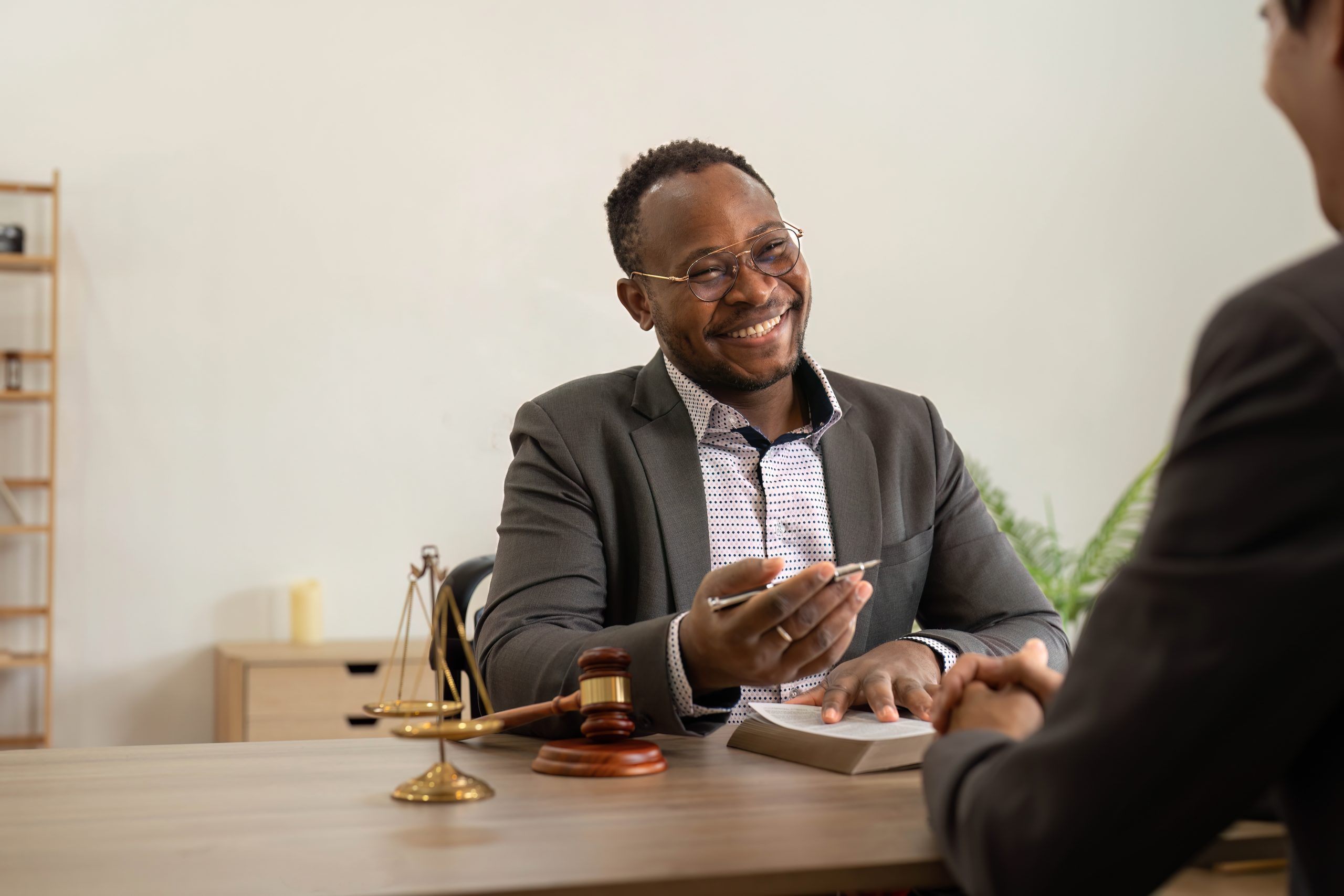 lawyer-and-client signing legal documents to start their case with and orlando lawyer using a flexible payment plan.