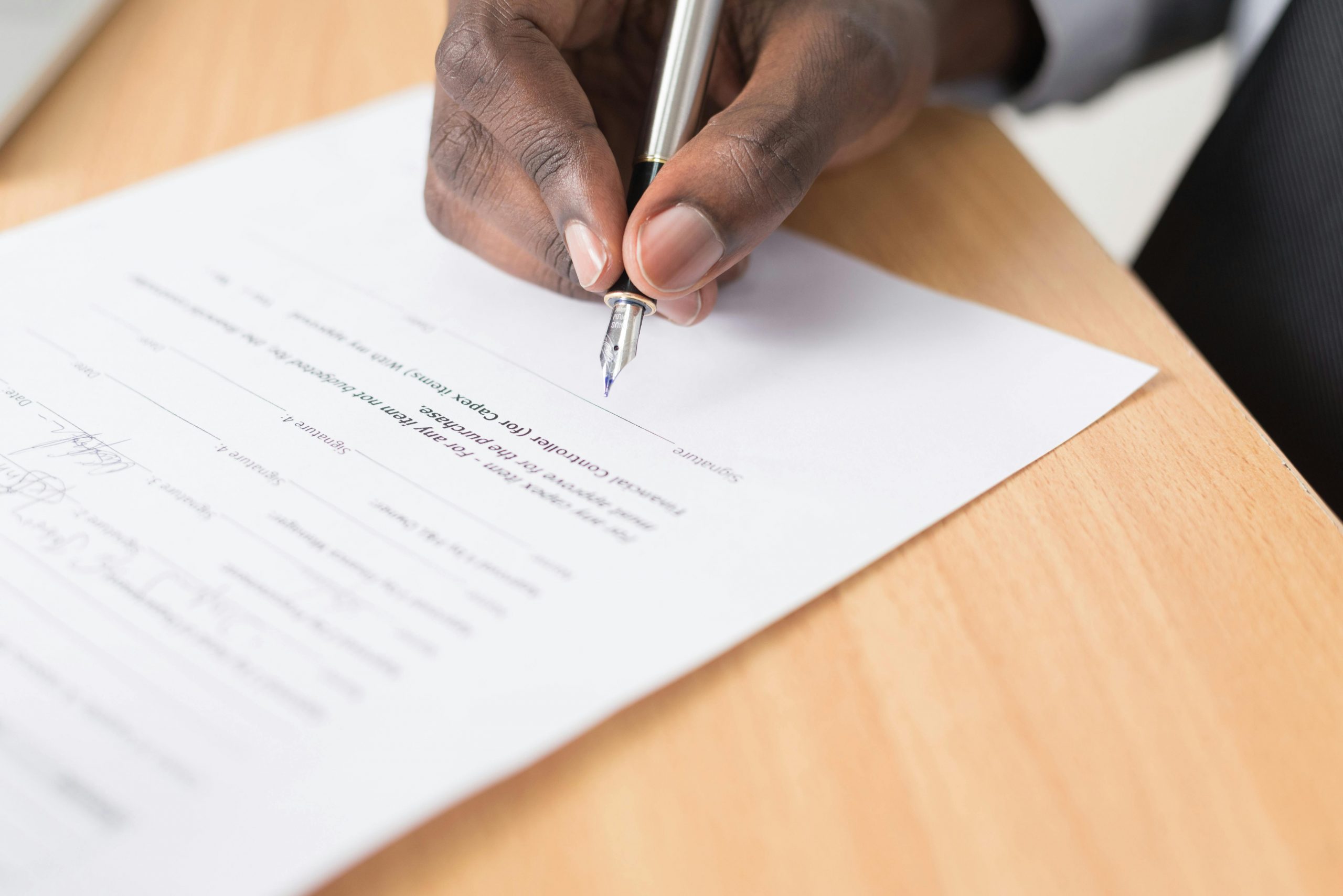 Black gentleman filling out legal forms during a lawyer payment plan consultation in orlando